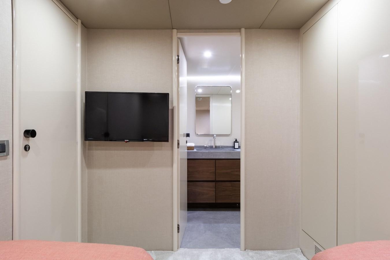 a bathroom with a tv and a sink aboard AXELLA Yacht for Sale
