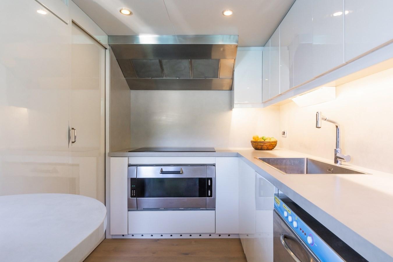 a kitchen with white cabinets aboard AXELLA Yacht for Sale
