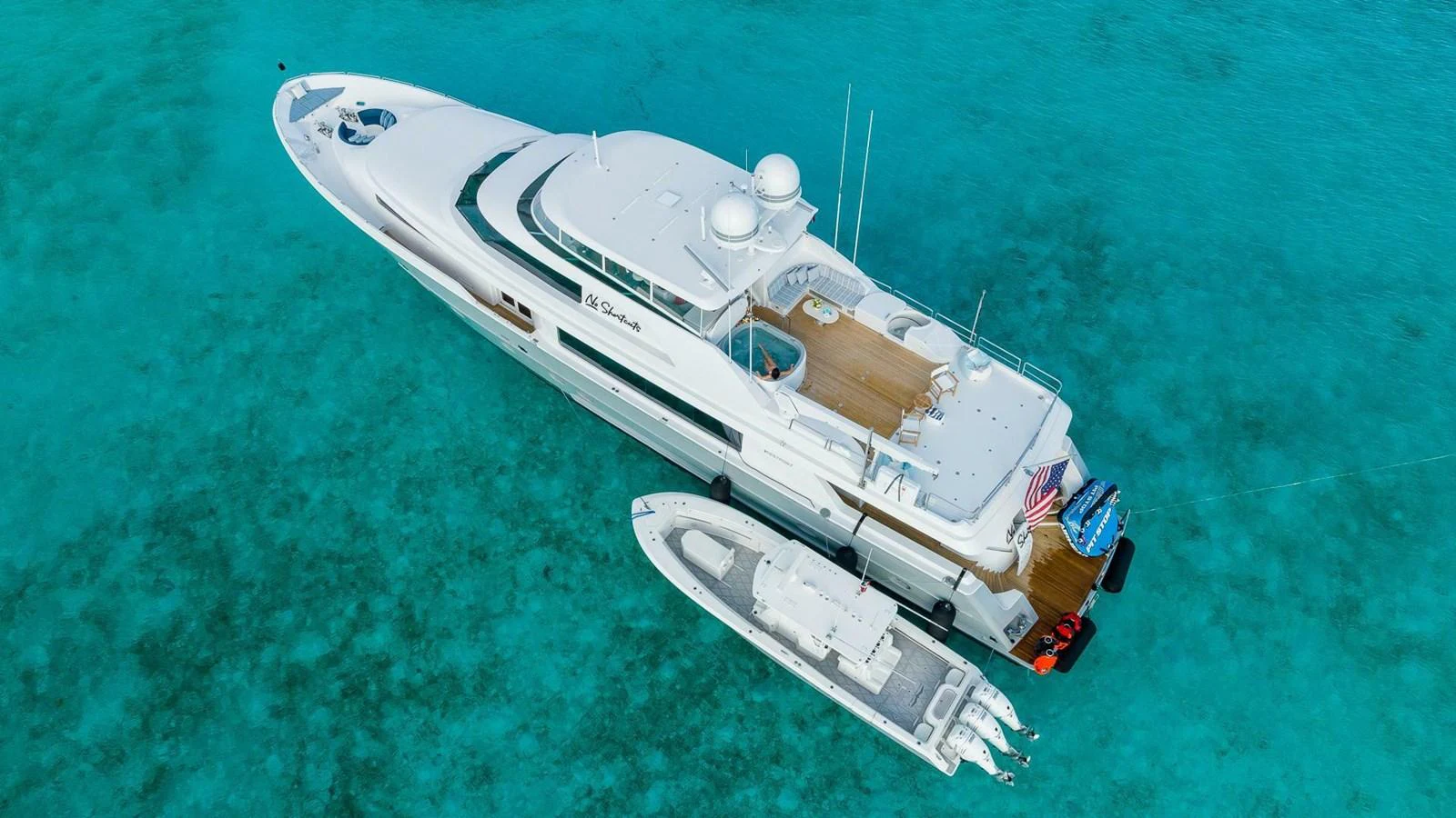 a jet flying over a body of water aboard NO SHORTCUTS Yacht for Sale