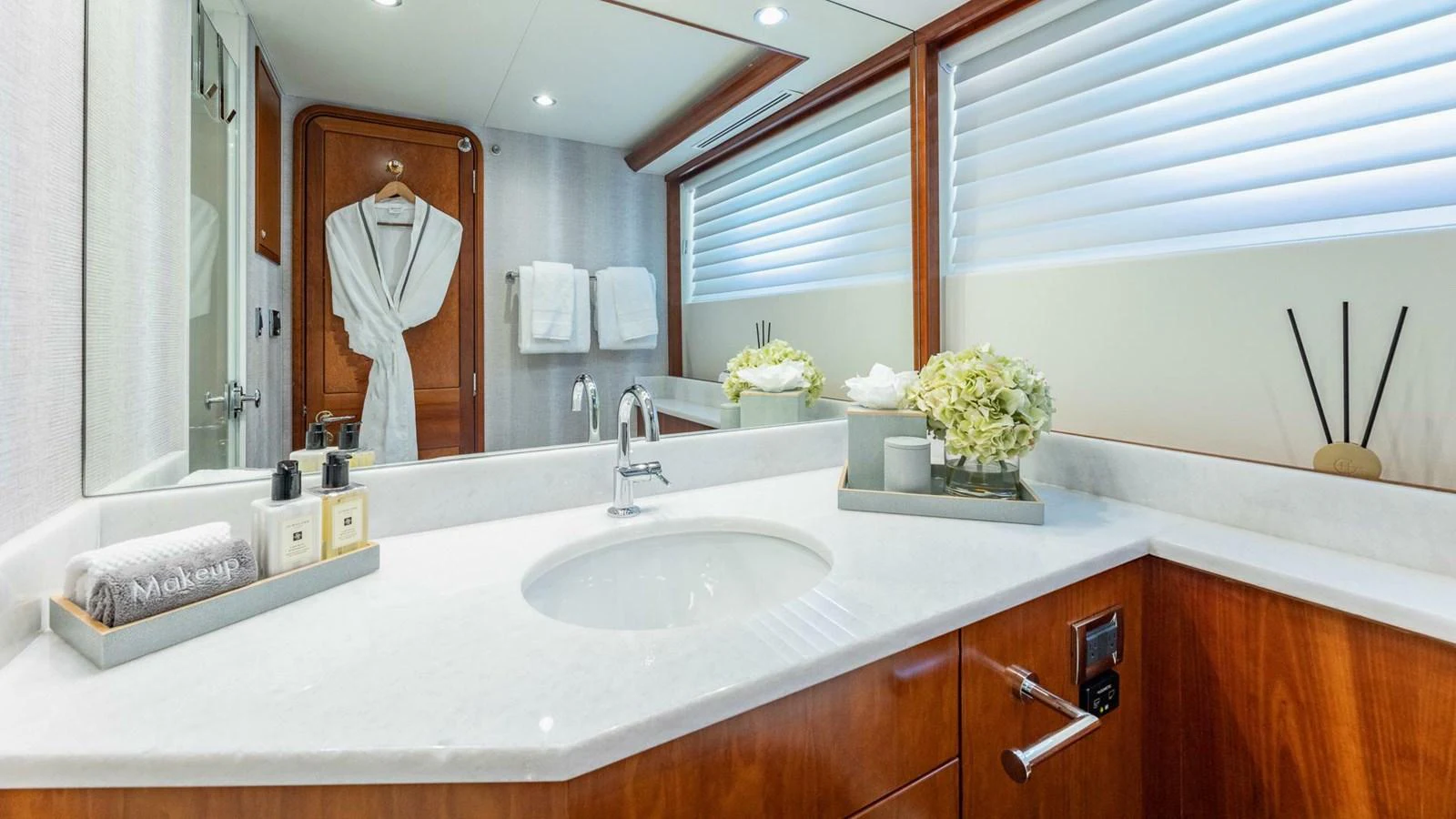 a person taking a picture of themselves in a bathroom mirror aboard NO SHORTCUTS Yacht for Sale