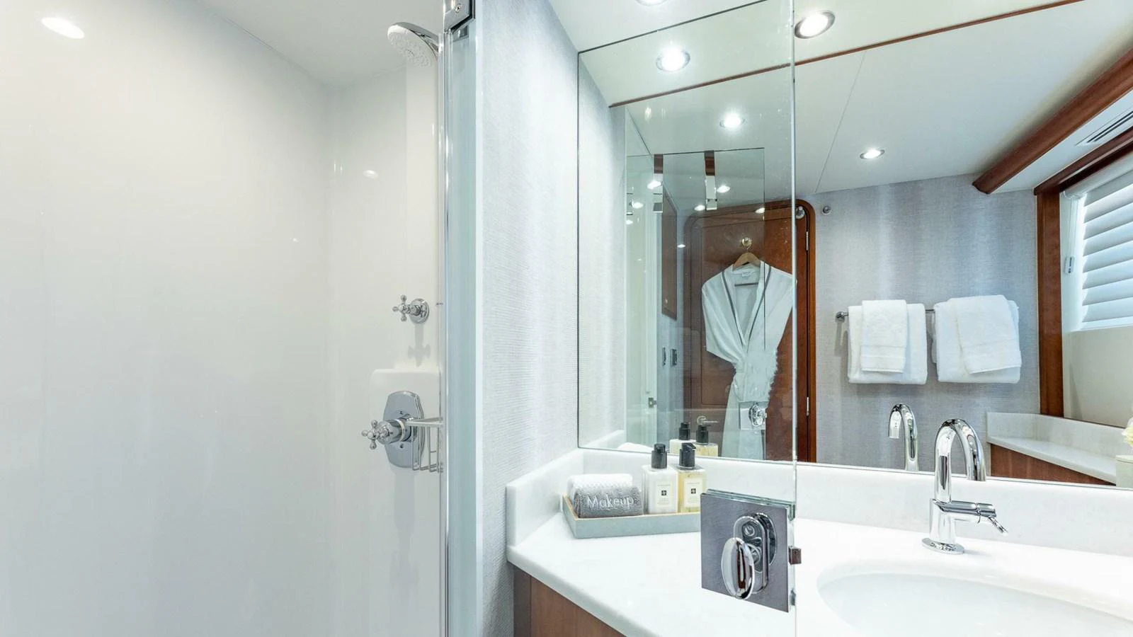 a person taking a picture of themselves in a bathroom mirror aboard NO SHORTCUTS Yacht for Sale