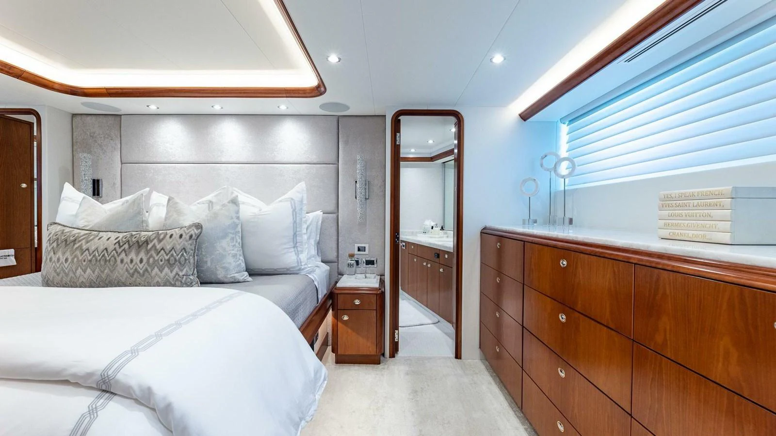 a bedroom with a bed and a dresser aboard NO SHORTCUTS Yacht for Sale