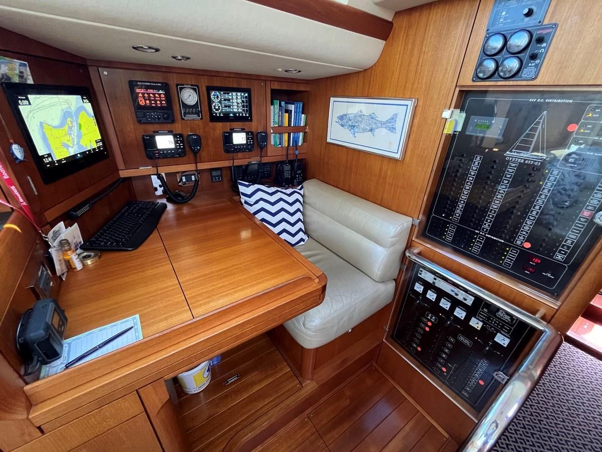 a living room with a television and a table aboard WEATHERLY Yacht for Sale