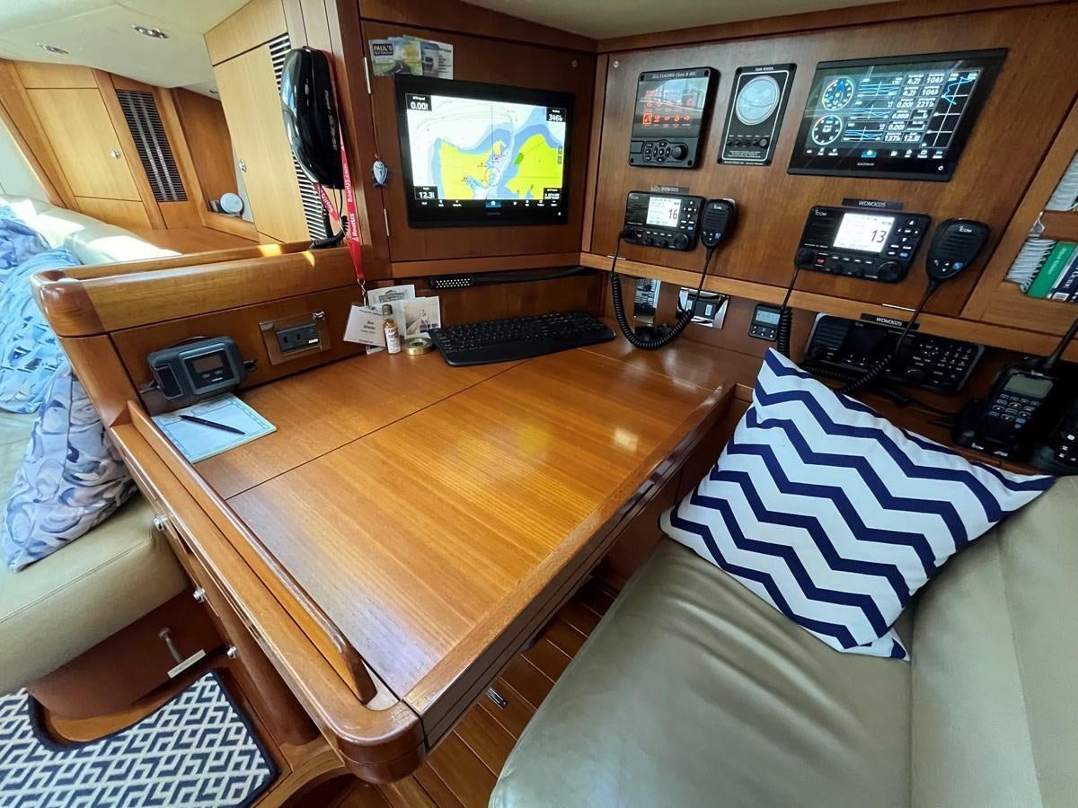 a living room with a television and a table aboard WEATHERLY Yacht for Sale