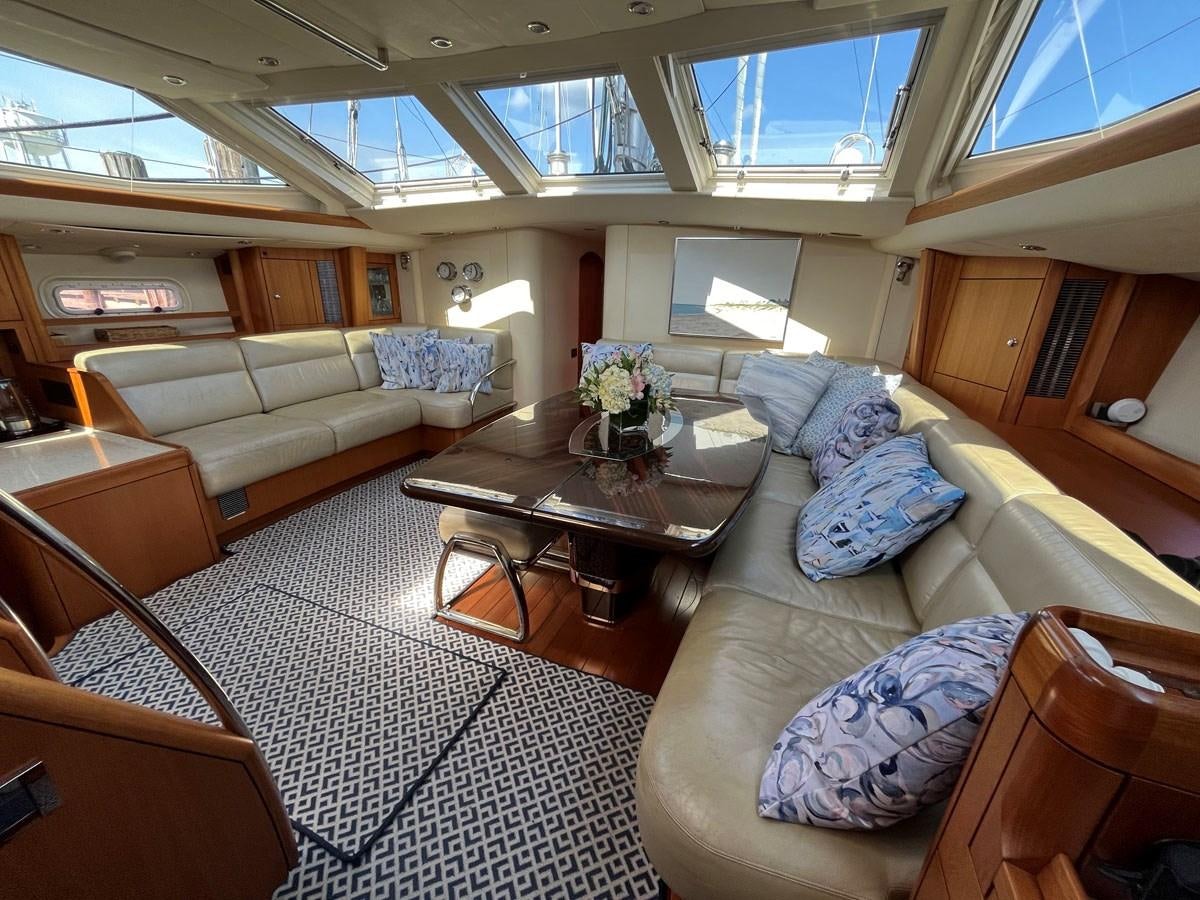 a living room with a couch and a coffee table aboard WEATHERLY Yacht for Sale