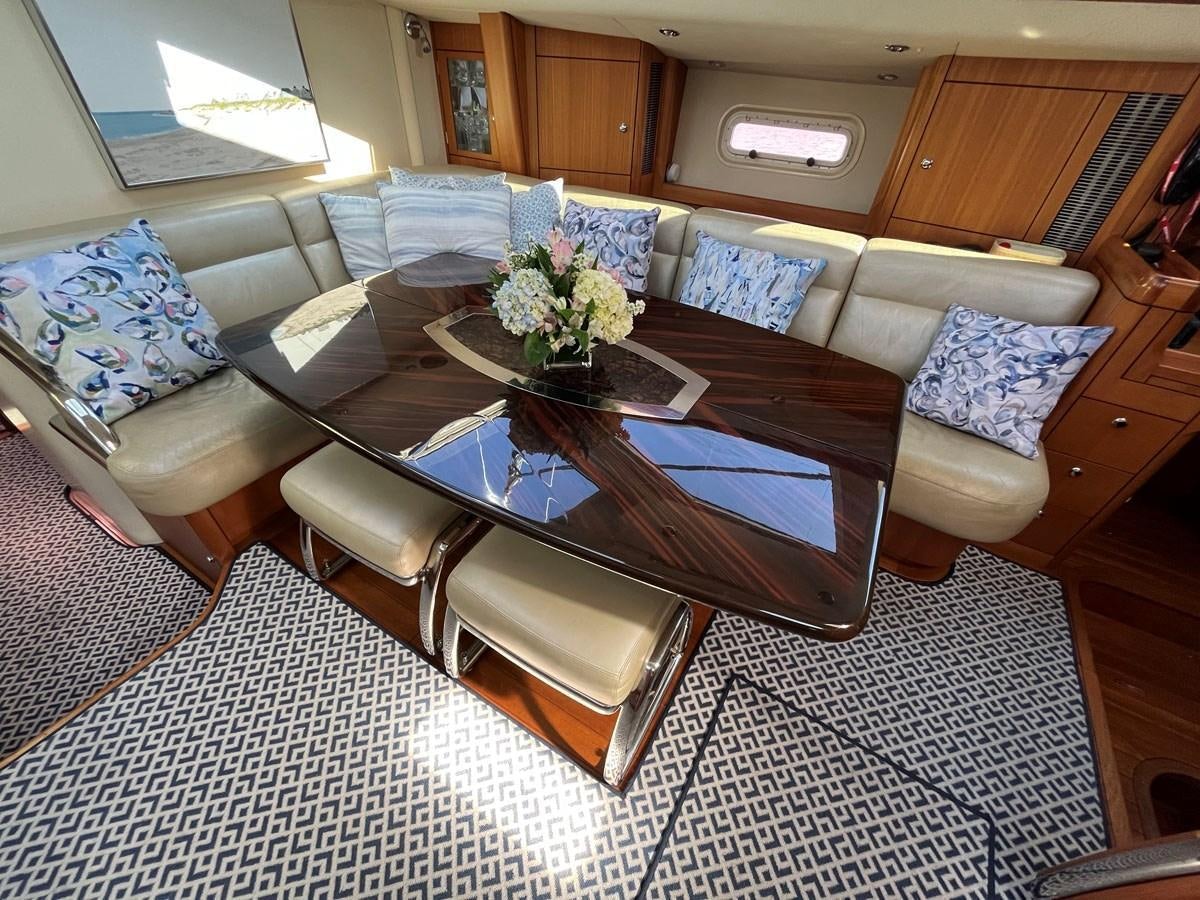a living room with a couch and coffee table aboard WEATHERLY Yacht for Sale