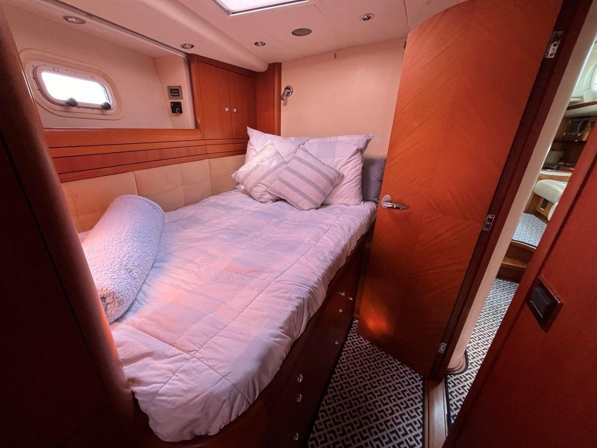 a bed with pink sheets aboard WEATHERLY Yacht for Sale