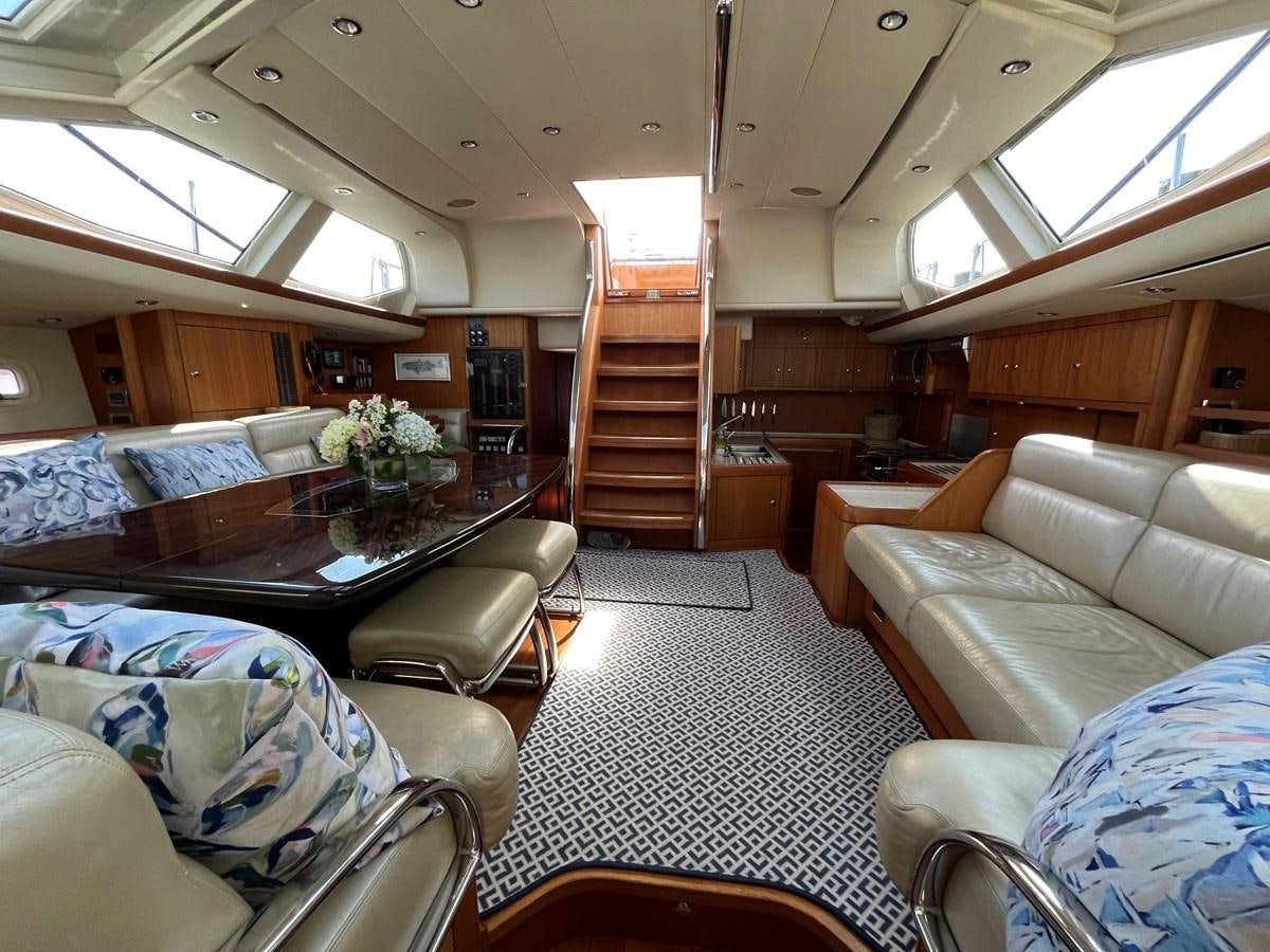 a living room with a large open staircase aboard WEATHERLY Yacht for Sale