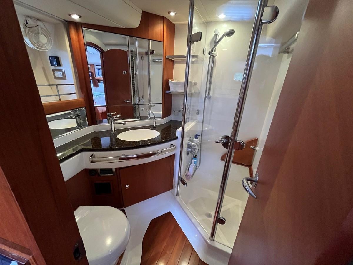 a bathroom with a glass shower aboard WEATHERLY Yacht for Sale