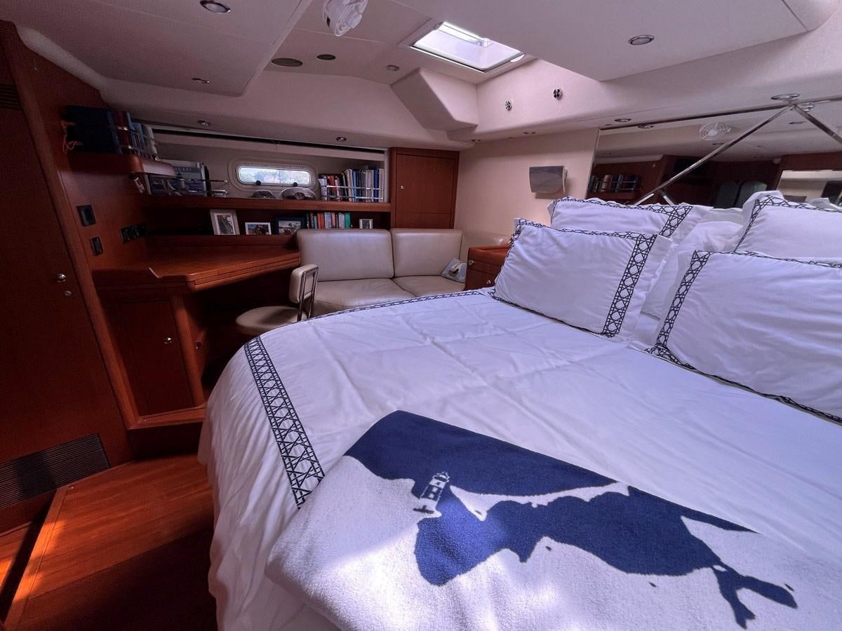 a bed with white sheets aboard WEATHERLY Yacht for Sale