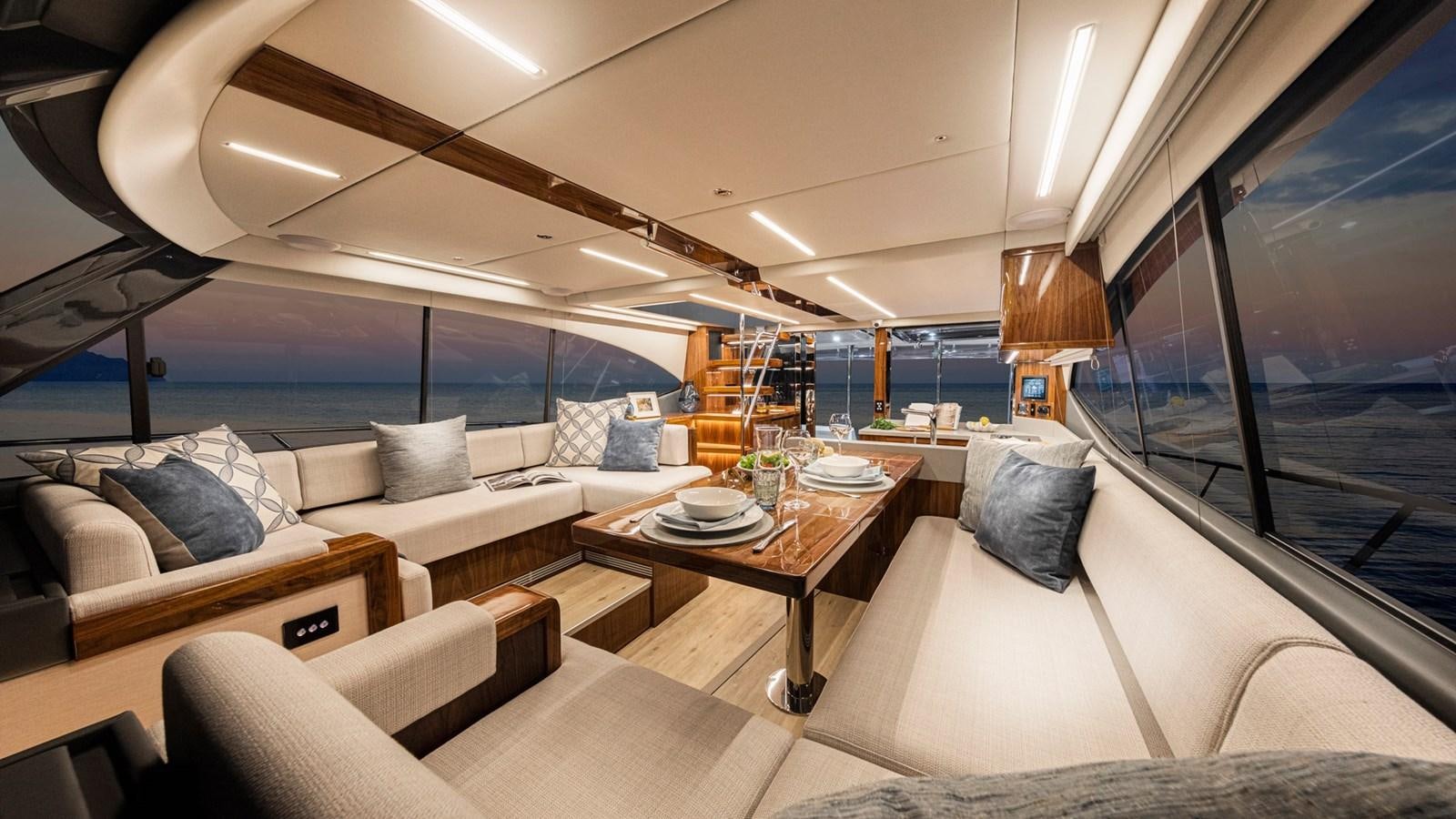 a room with a couch and a table and a large window aboard 72 SPORTS MOTOR YACHT Yacht for Sale