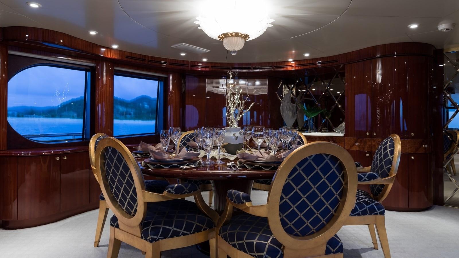 a room with a table and chairs aboard TOUCH Yacht for Sale