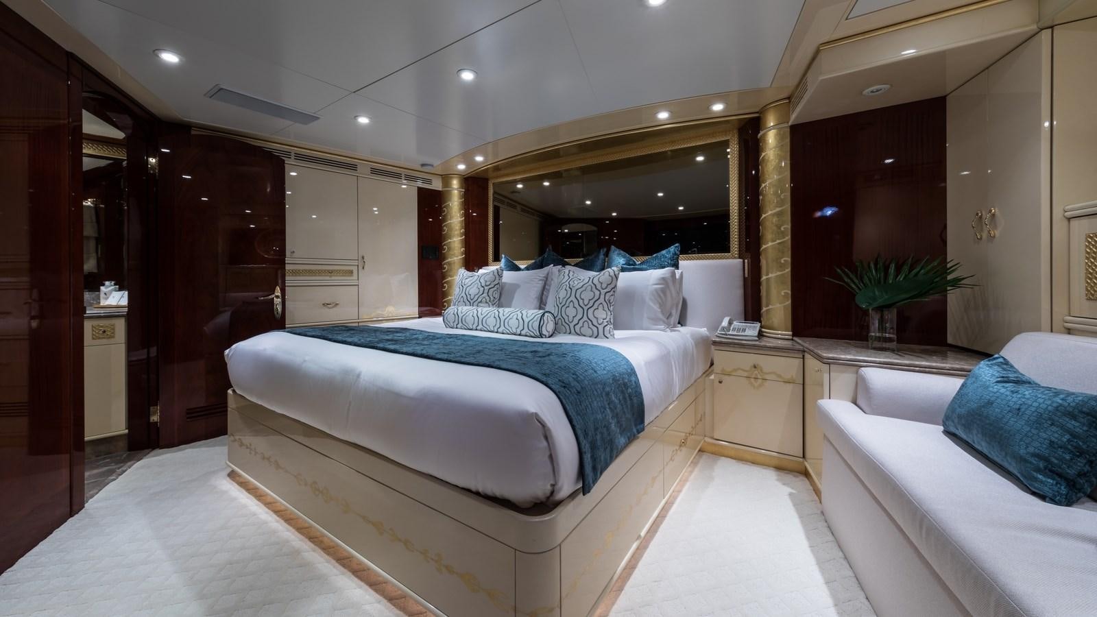 a room with a bed and a mirror aboard TOUCH Yacht for Sale