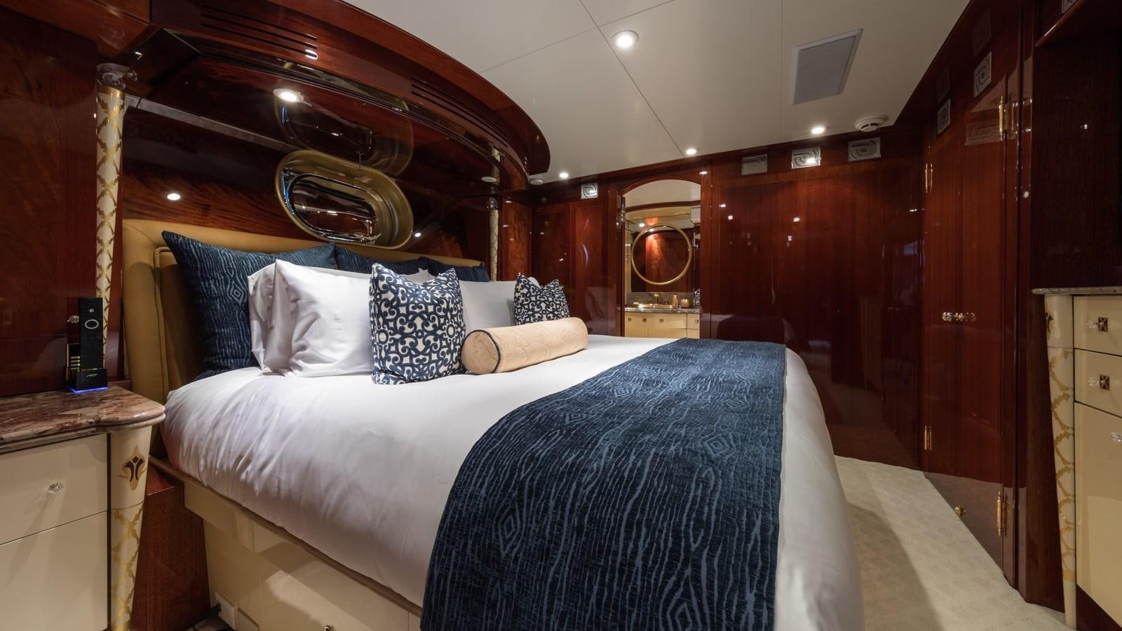 a bed with a mirror above it aboard TOUCH Yacht for Sale