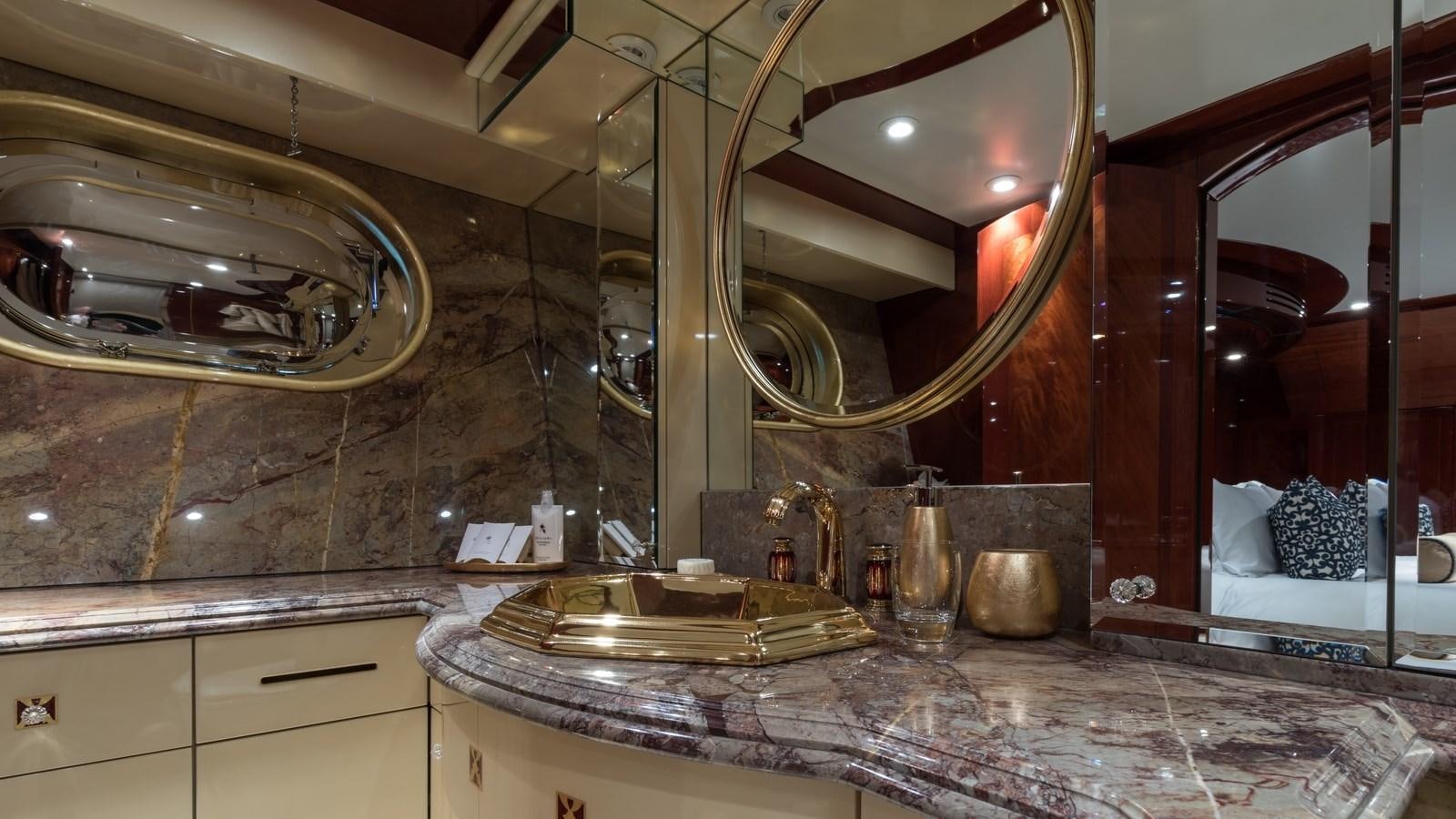 a fancy bathroom with a large mirror aboard TOUCH Yacht for Sale