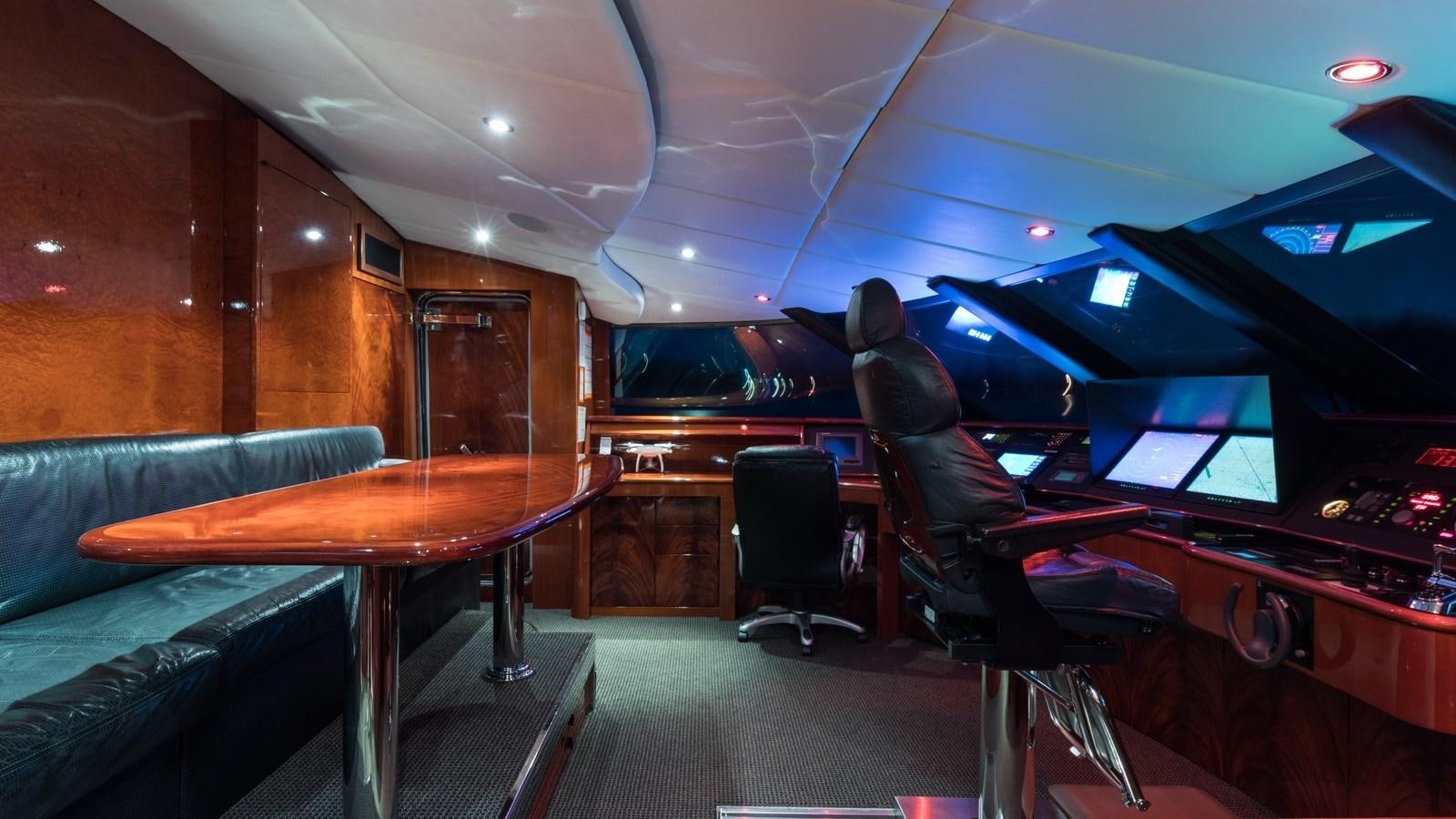 a room with a table and chairs aboard TOUCH Yacht for Sale