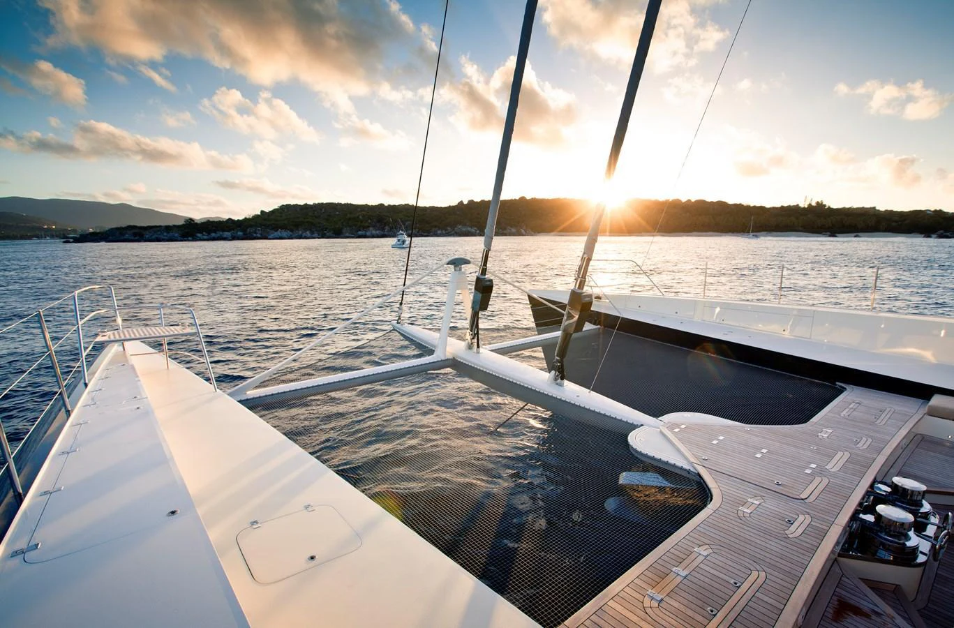 The yacht's deck offers a stunning view of the sunset over the water, highlighting its spacious and elegant design. aboard HEMISPHERE Yacht for Sale