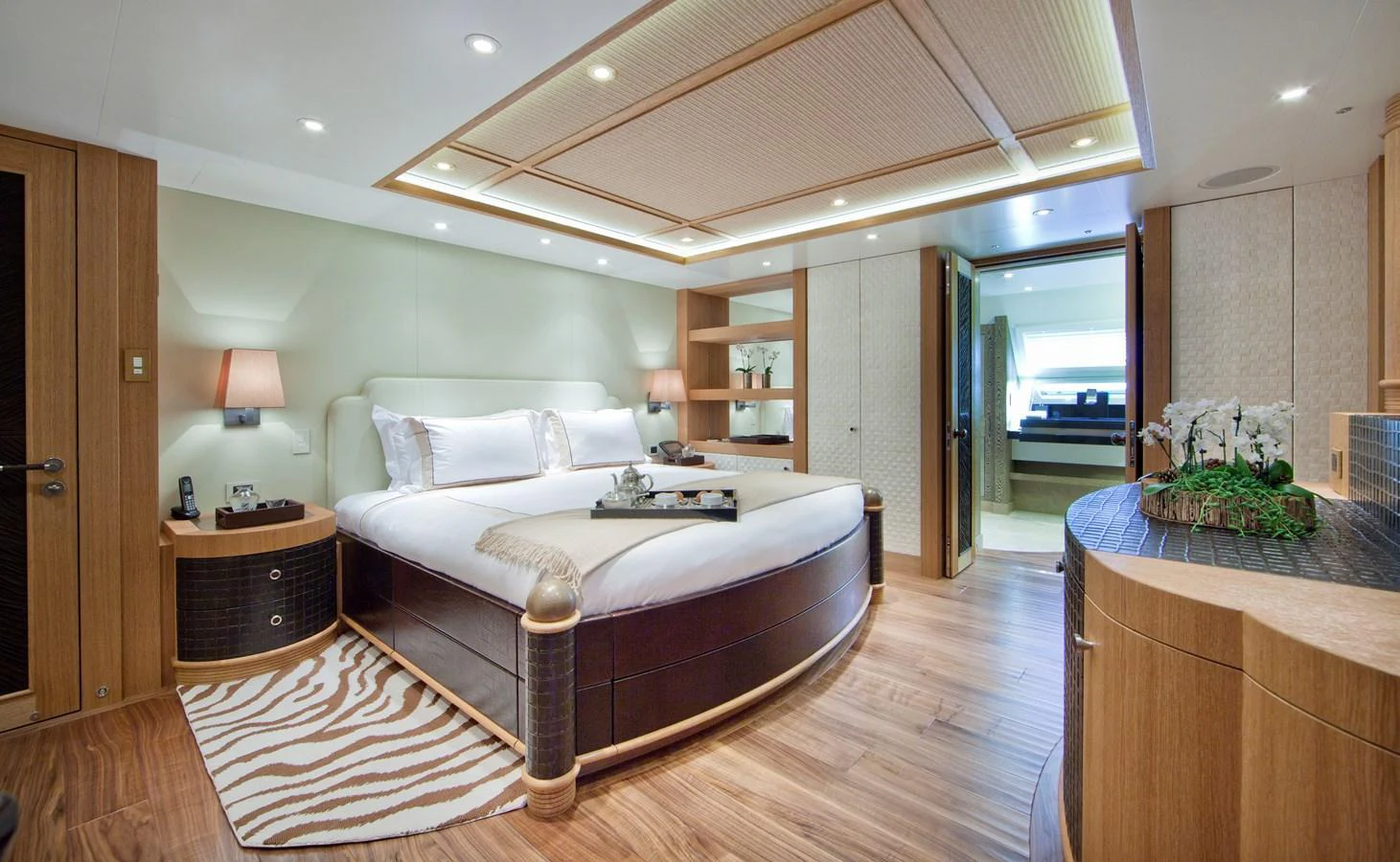 The master stateroom features a luxurious bed, elegant wood finishes, and modern amenities. aboard HEMISPHERE Yacht for Sale