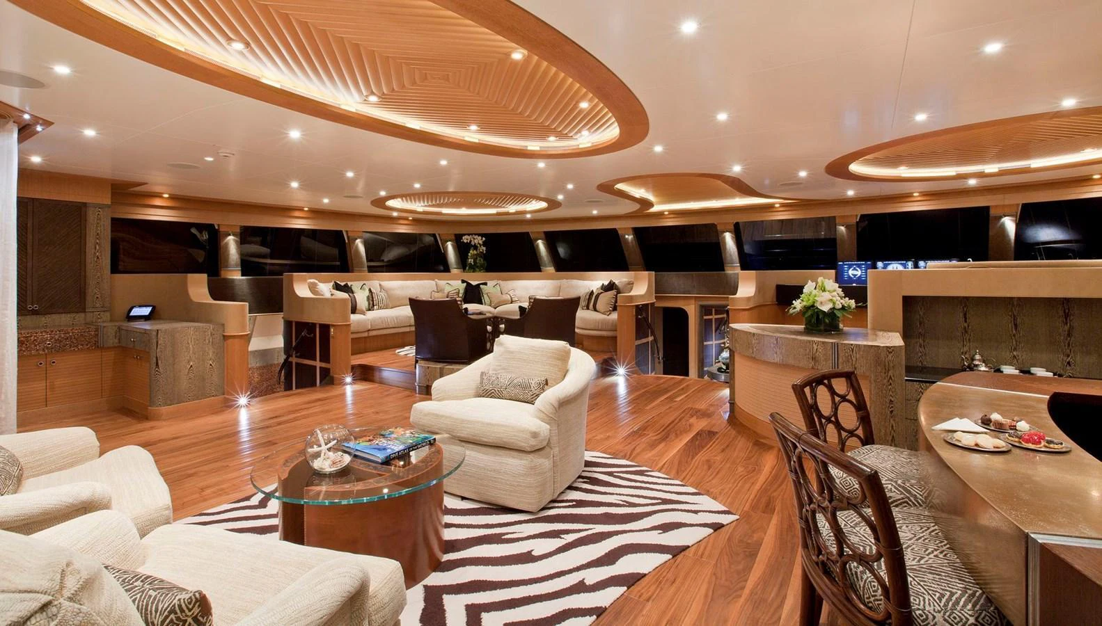 The salon features luxurious seating, elegant decor, and ample natural light. aboard HEMISPHERE Yacht for Sale