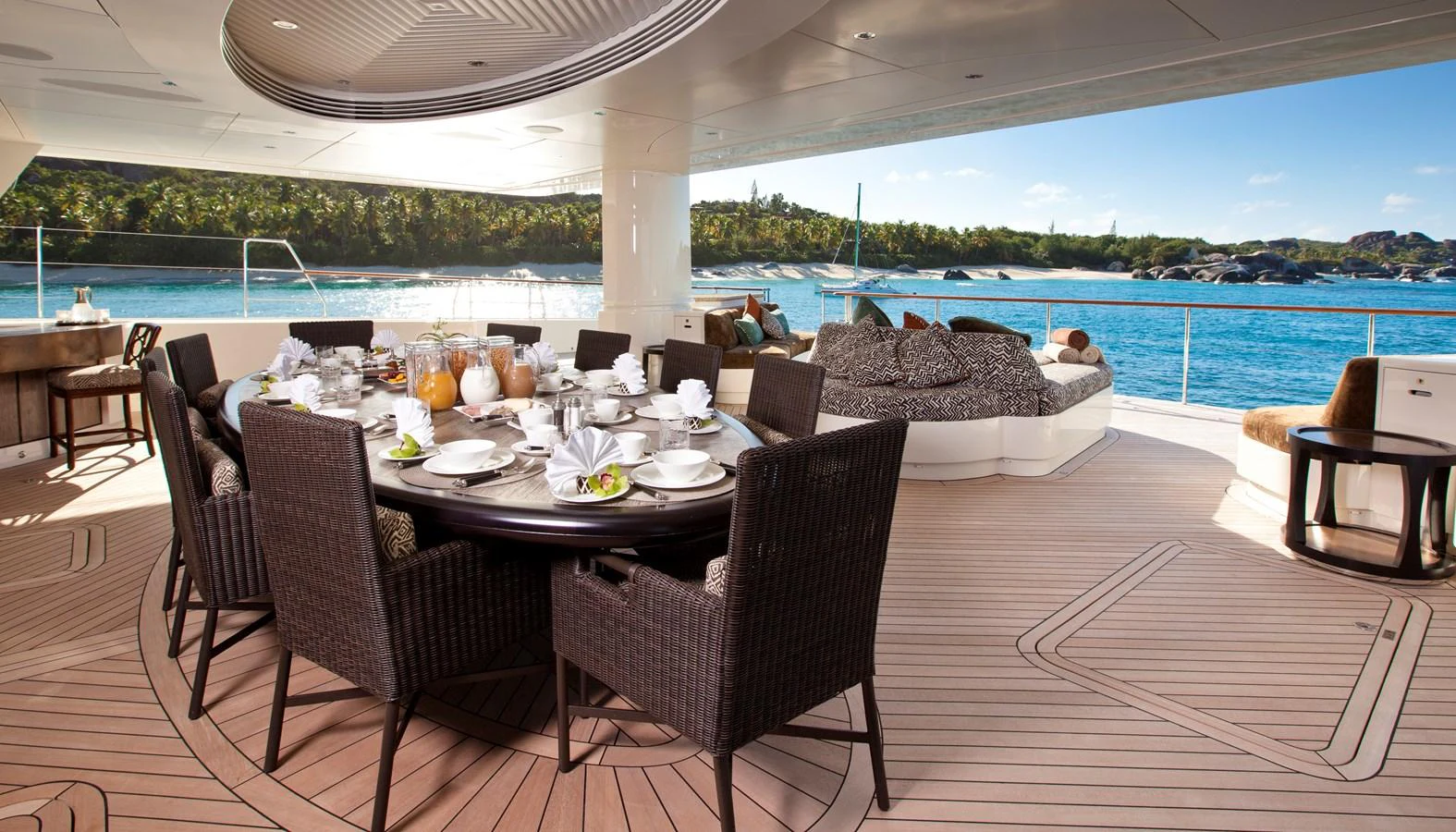 The aft deck features an elegant dining area with a stunning ocean view. aboard HEMISPHERE Yacht for Sale