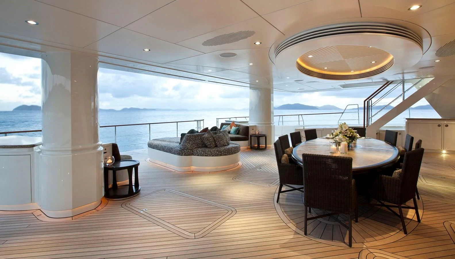 The aft deck offers a luxurious outdoor dining area with stunning ocean views. aboard HEMISPHERE Yacht for Sale