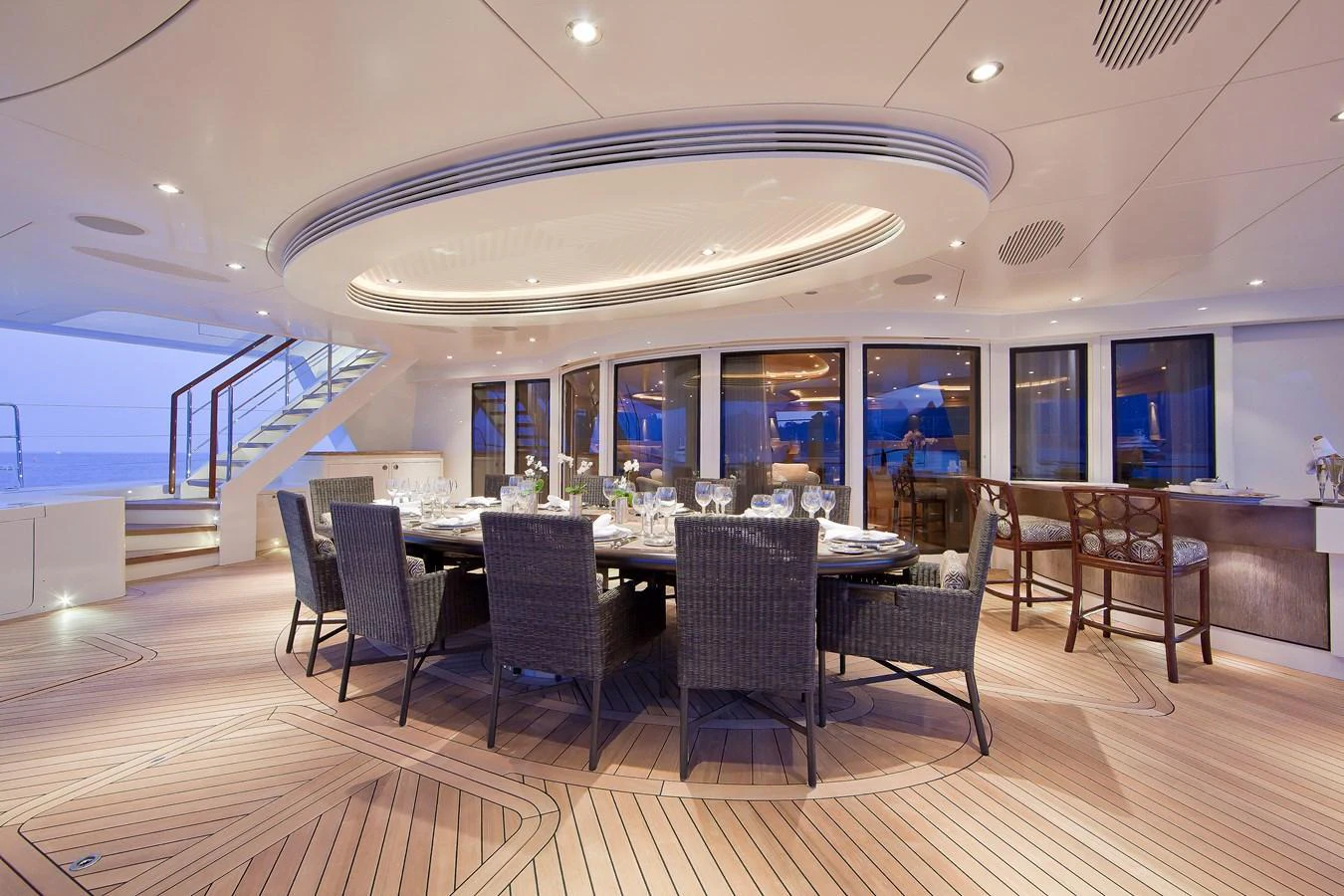 The aft deck features an elegant dining area with a large table and comfortable seating, perfect for alfresco dining. aboard HEMISPHERE Yacht for Sale