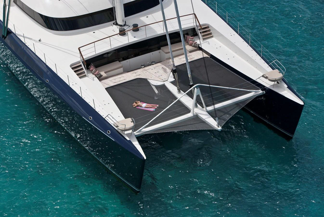 A luxurious catamaran with a spacious netted lounging area over the water. aboard HEMISPHERE Yacht for Sale