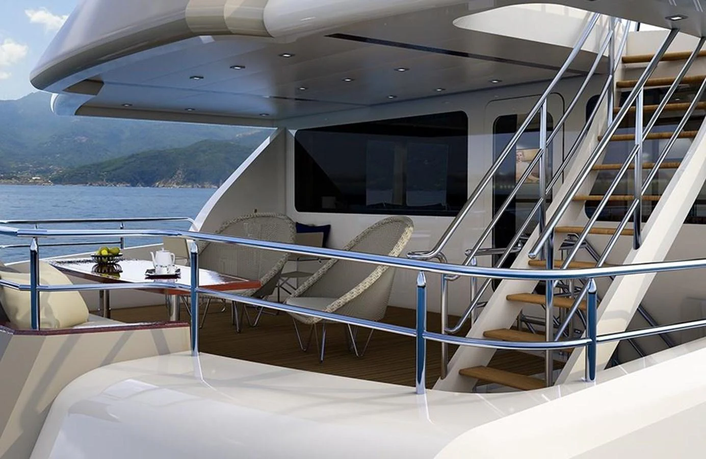 The aft deck features a cozy seating area and a staircase leading to the upper deck, perfect for relaxation and enjoying the view. aboard NORTHLAND Yacht for Sale