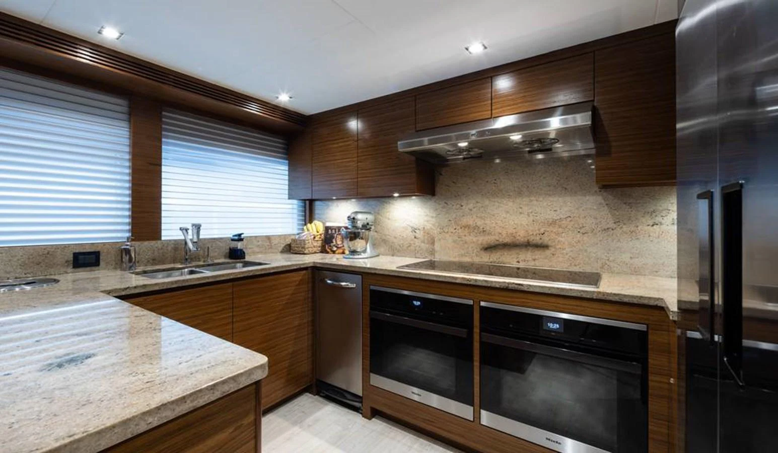 The galley features modern appliances and sleek wooden cabinetry, creating a sophisticated cooking space. aboard NORTHLAND Yacht for Sale