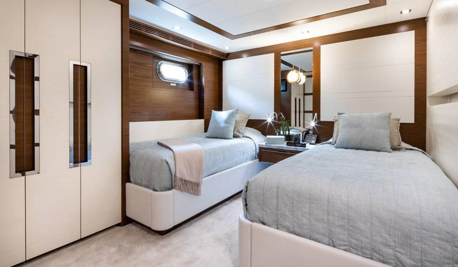 The guest stateroom features twin beds with elegant bedding and modern decor. aboard NORTHLAND Yacht for Sale