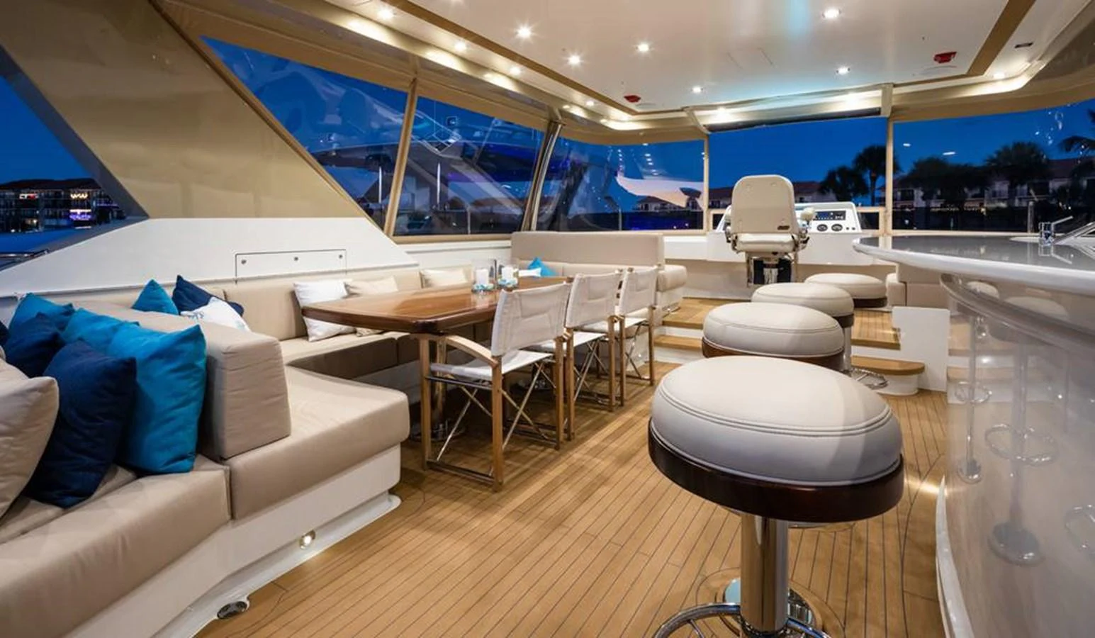 The salon features elegant seating, a dining area, and a helm station with panoramic views. aboard NORTHLAND Yacht for Sale