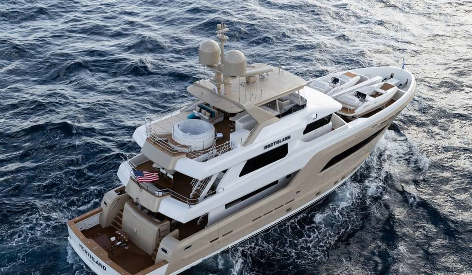 A luxurious yacht cruises through the open sea, showcasing its elegant design and spacious decks. aboard NORTHLAND Yacht for Sale