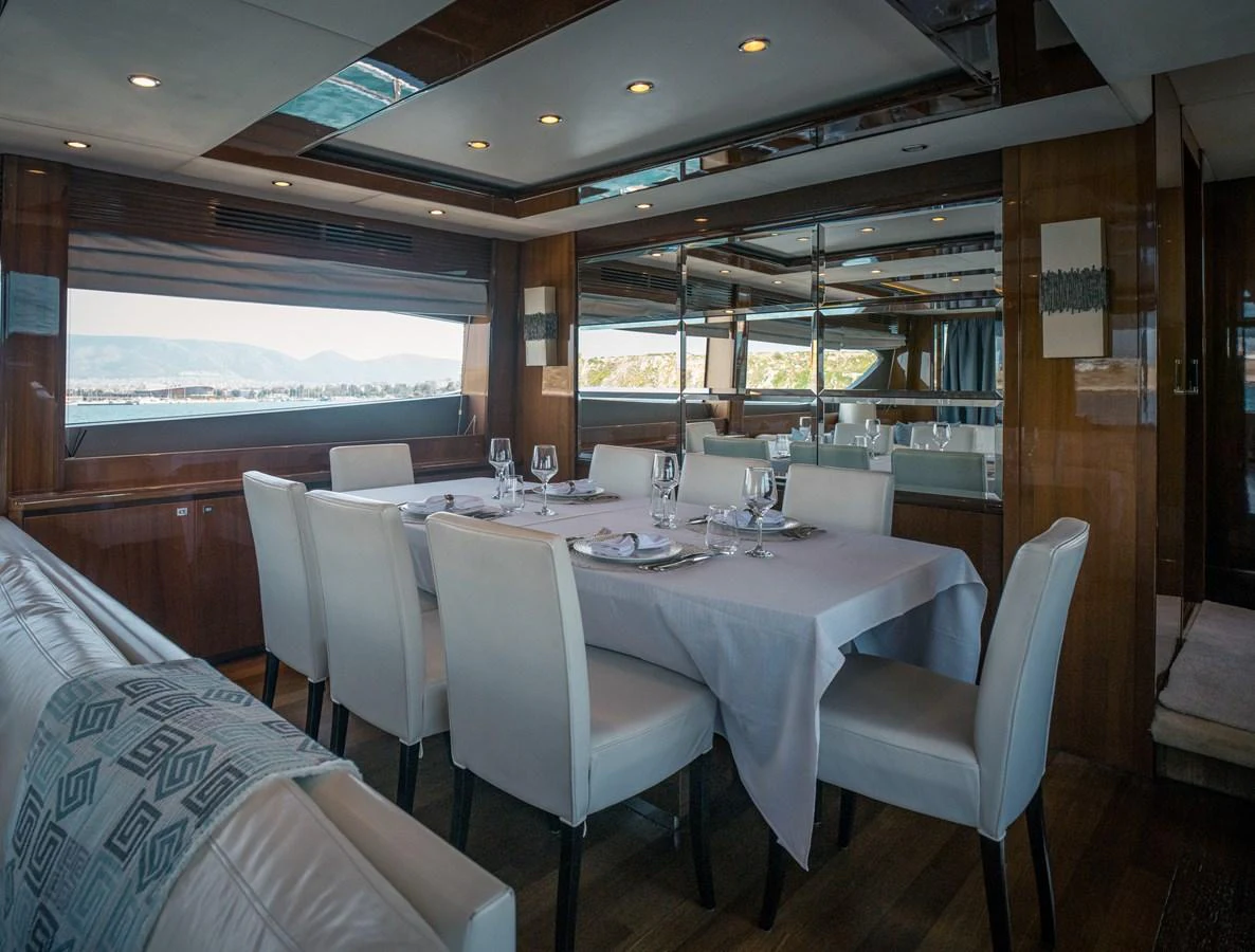 The yacht's dining area features a sophisticated table setting with ample seating and elegant decor. aboard 4 LIFE Yacht for Sale