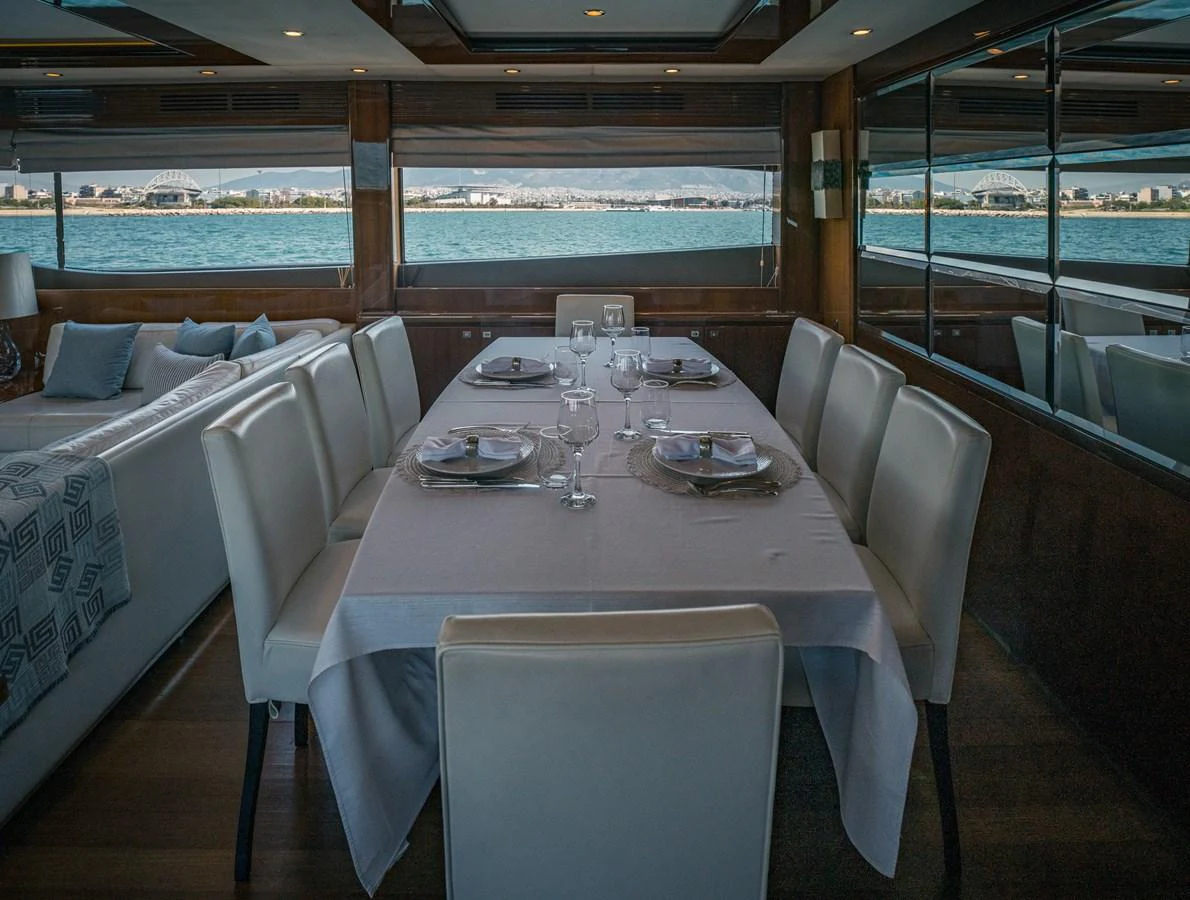 The yacht's dining area offers a sophisticated setting with panoramic views of the water. aboard 4 LIFE Yacht for Sale