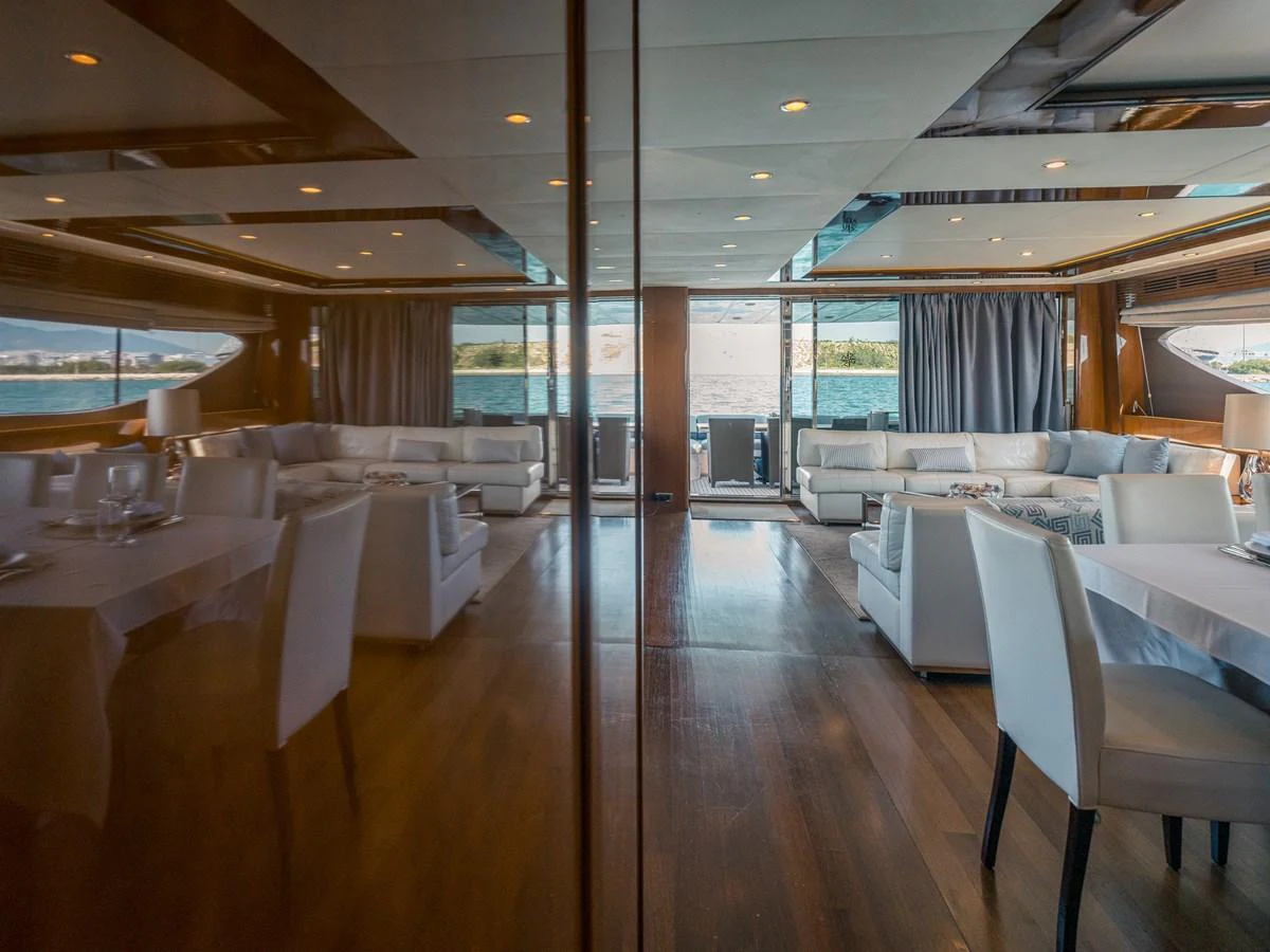 The yacht's salon features elegant seating and dining areas with expansive windows offering stunning views. aboard 4 LIFE Yacht for Sale