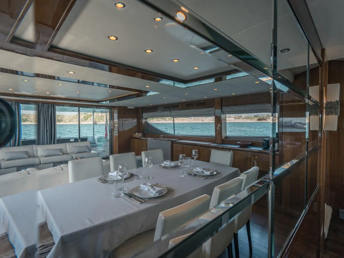 The yacht's dining area features elegant table settings and large windows offering scenic views. aboard 4 LIFE Yacht for Sale