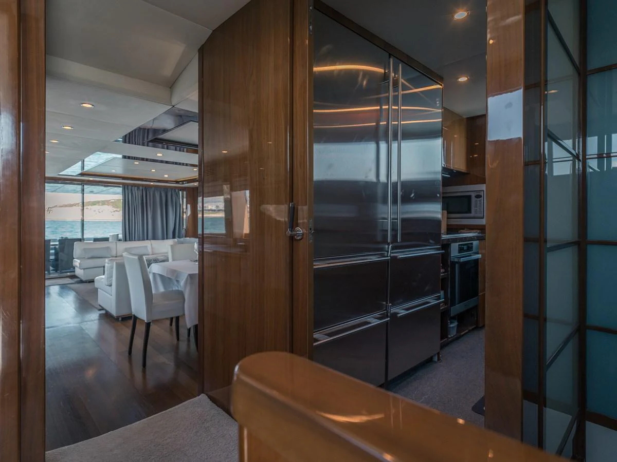 The yacht's galley features modern appliances and a sleek design, seamlessly connecting to the dining area. aboard 4 LIFE Yacht for Sale