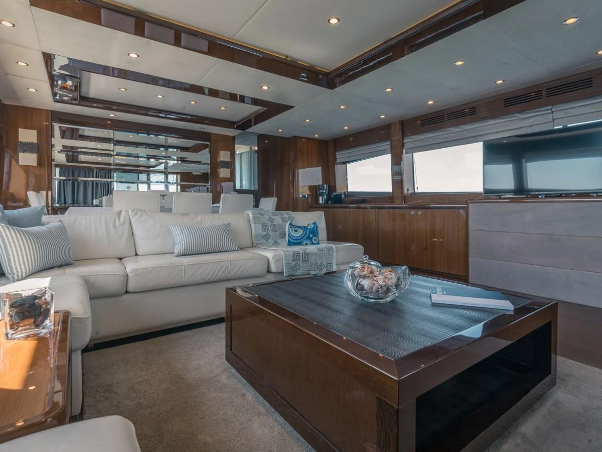 The yacht's salon features a luxurious seating area with plush cushions and elegant wooden accents. aboard 4 LIFE Yacht for Sale