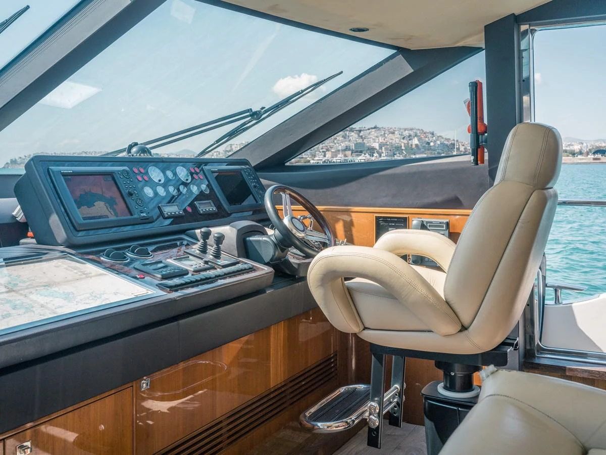 The helm station features a sophisticated control panel with a comfortable captain's chair and panoramic windows offering a scenic view. aboard 4 LIFE Yacht for Sale