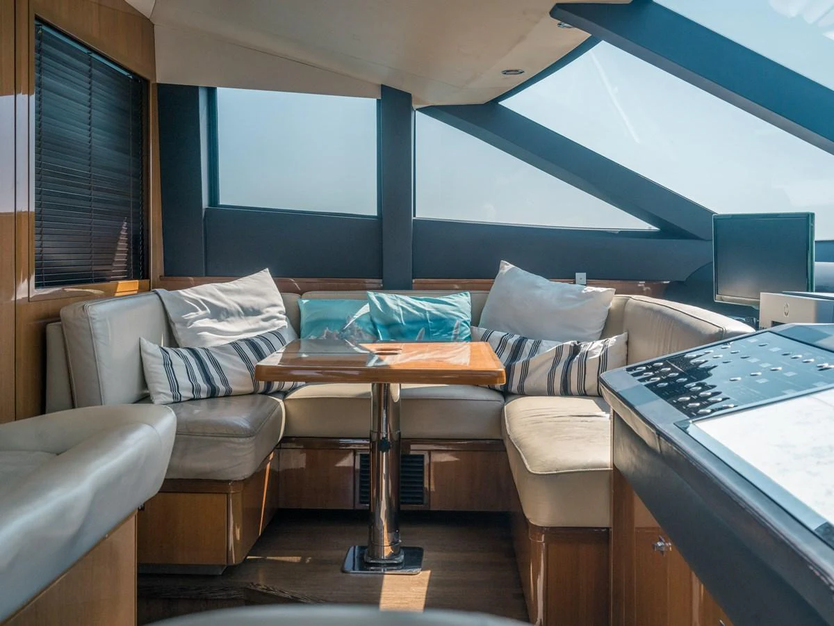 The salon features a cozy seating area with plush cushions and ample natural light from large windows. aboard 4 LIFE Yacht for Sale