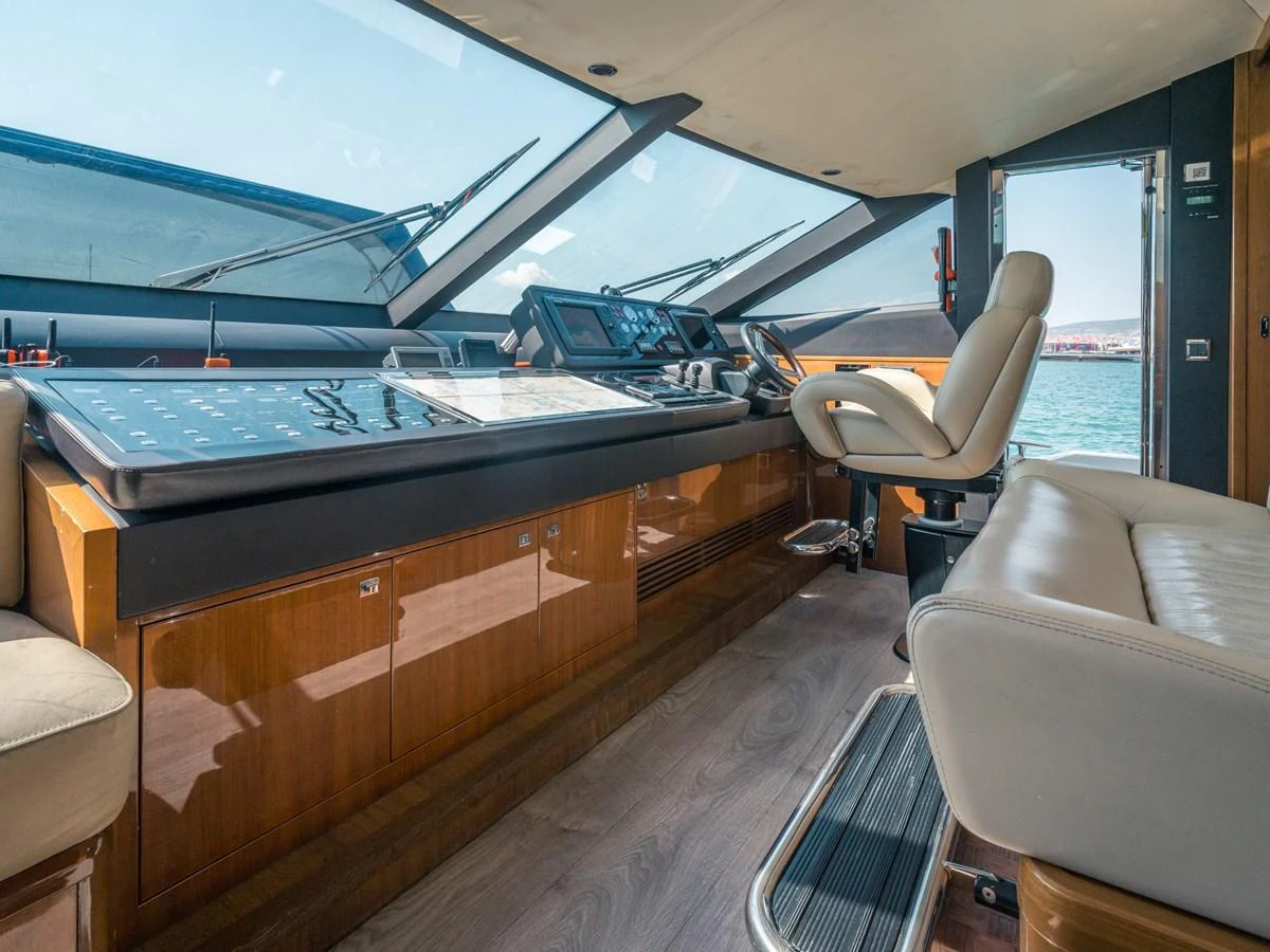 The helm station features modern navigation equipment and luxurious seating with a panoramic view. aboard 4 LIFE Yacht for Sale