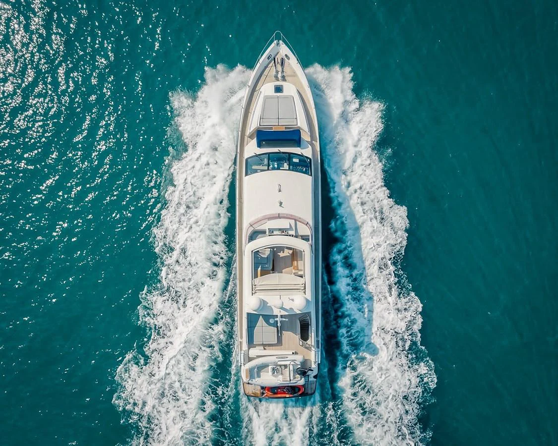 Aerial view of a sleek yacht cruising through clear blue waters. aboard 4 LIFE Yacht for Sale