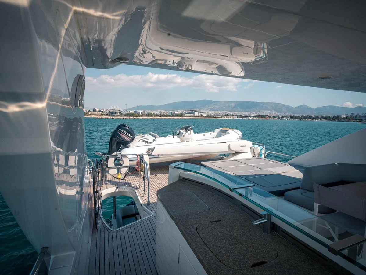 The aft deck features a tender and a comfortable lounging area with stunning views of the water. aboard 4 LIFE Yacht for Sale