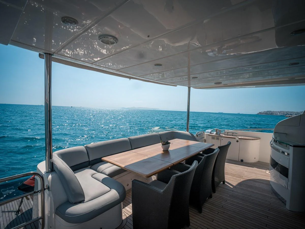 The aft deck features a spacious dining area with a stunning ocean view. aboard 4 LIFE Yacht for Sale