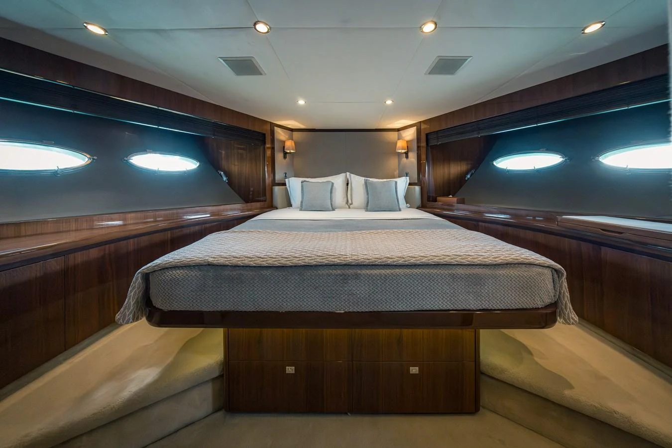 The master stateroom features a spacious bed with elegant wood paneling and ample natural light. aboard 4 LIFE Yacht for Sale