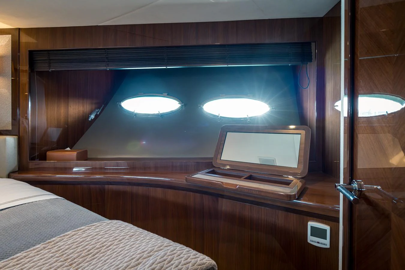 The stateroom features elegant wood paneling and ample natural light from porthole windows. aboard 4 LIFE Yacht for Sale