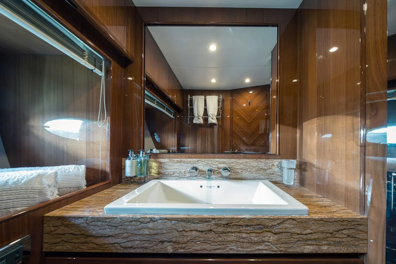 The yacht's bathroom features a luxurious bathtub with elegant wood paneling and modern fixtures. aboard 4 LIFE Yacht for Sale