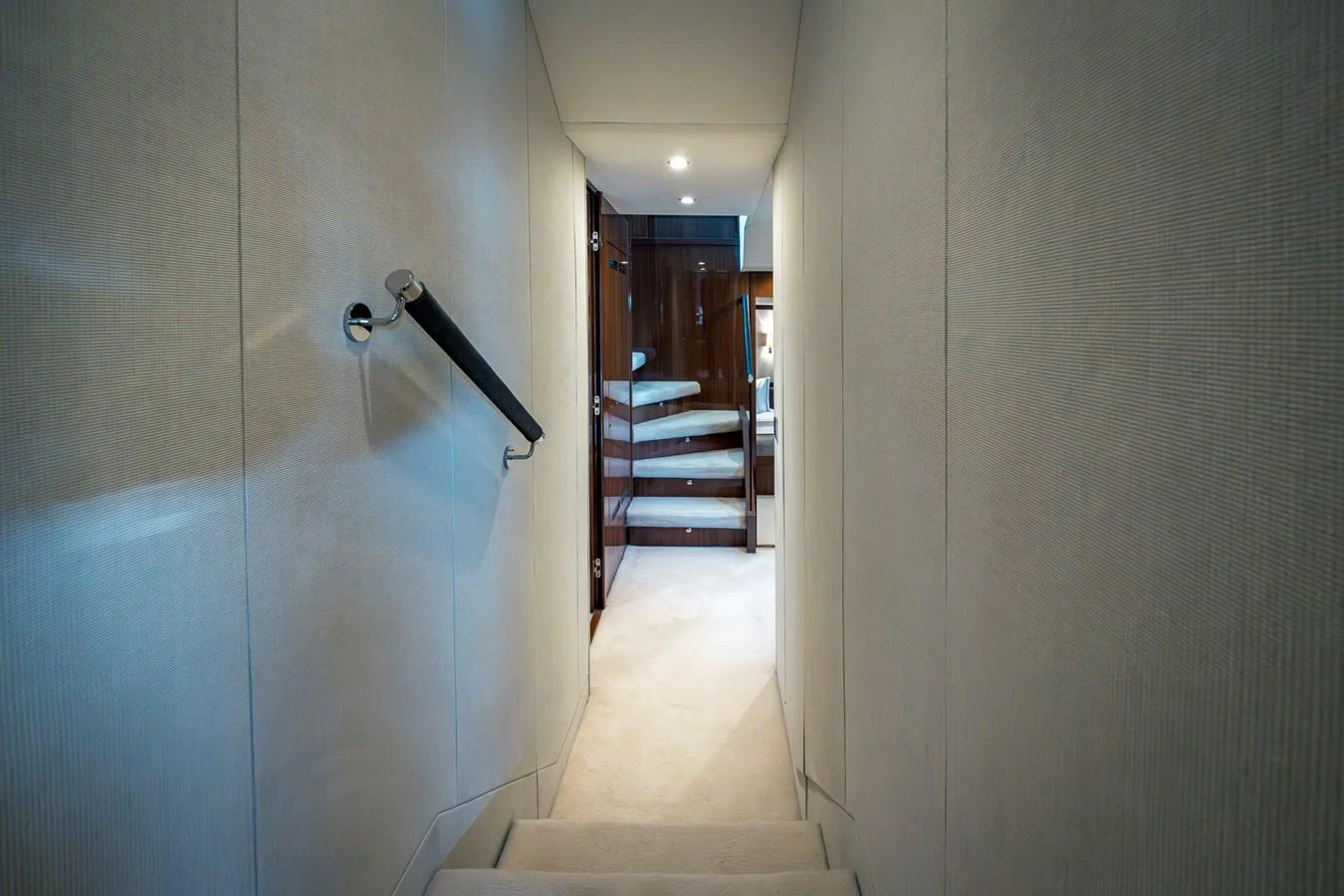 A sleek hallway with modern finishes leads to a luxurious cabin. aboard 4 LIFE Yacht for Sale