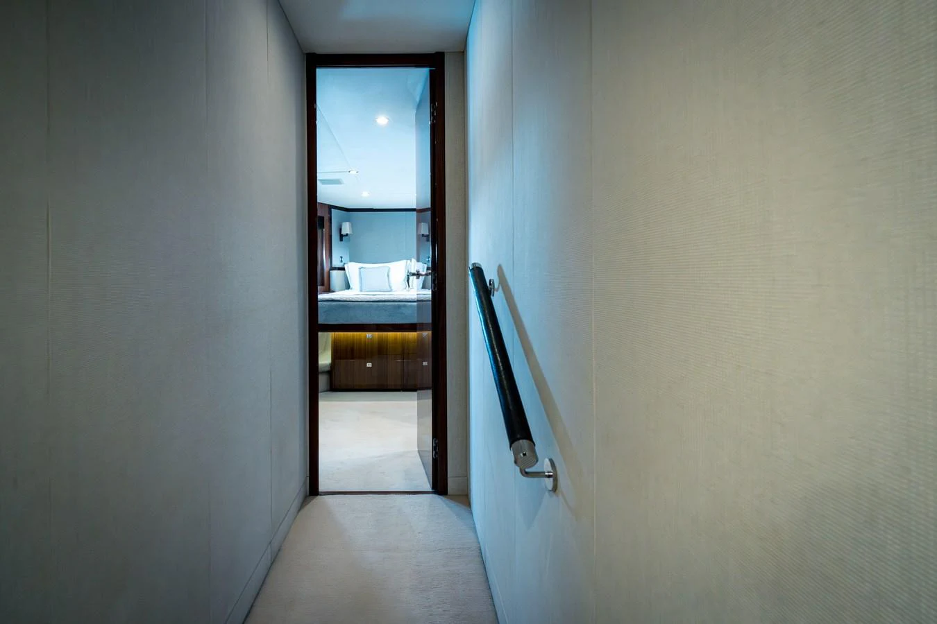 A sleek hallway leading to a luxurious stateroom, showcasing modern design and comfort. aboard 4 LIFE Yacht for Sale