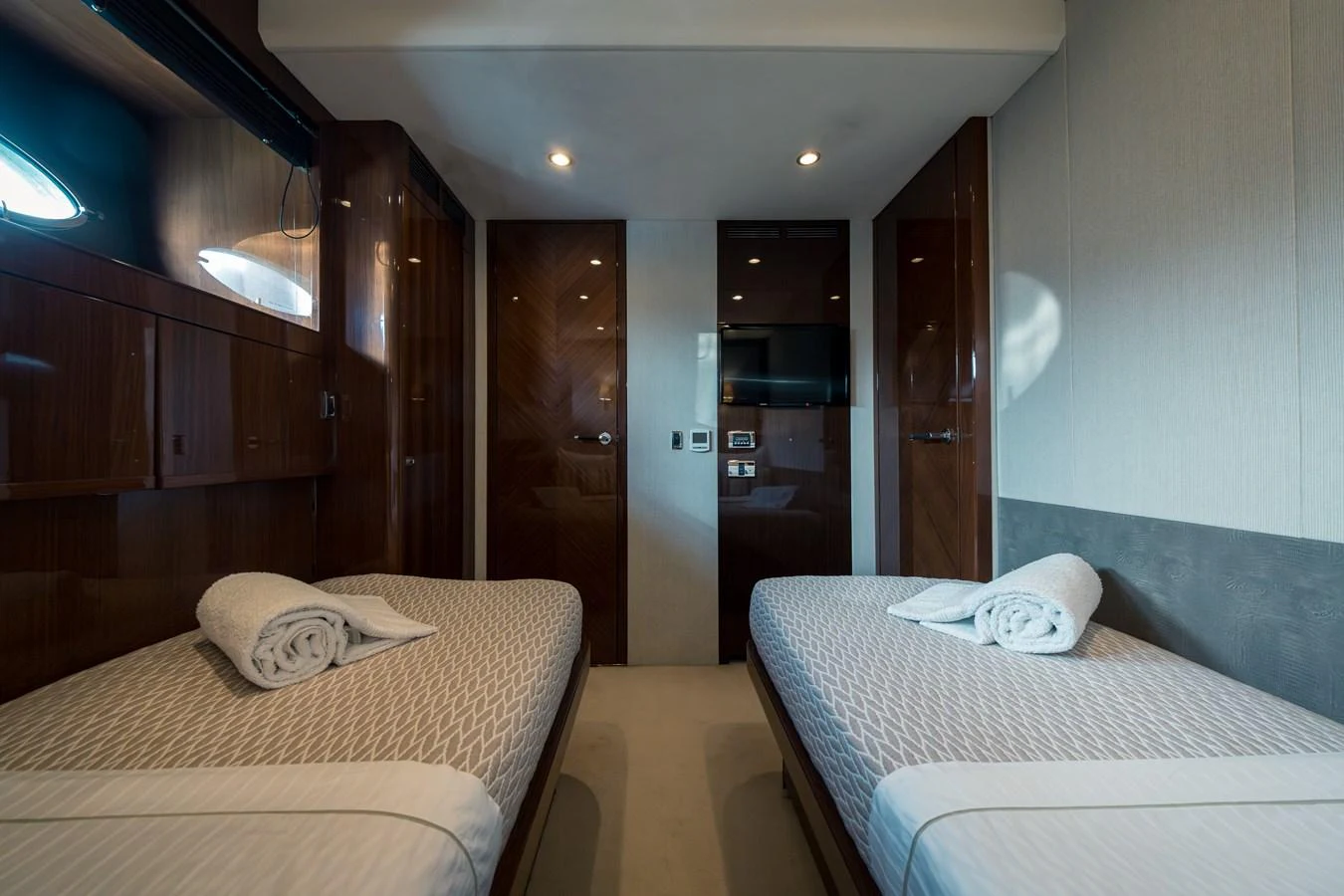The twin stateroom offers a cozy and elegant retreat with two single beds and modern amenities. aboard 4 LIFE Yacht for Sale